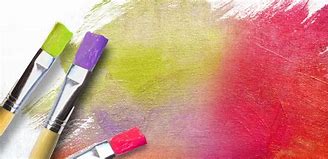 Art supplies including paintbrushes and vibrant red, yellow, and blue paint on a textured white canvas, symbolising creativity and expression in Art and Design.